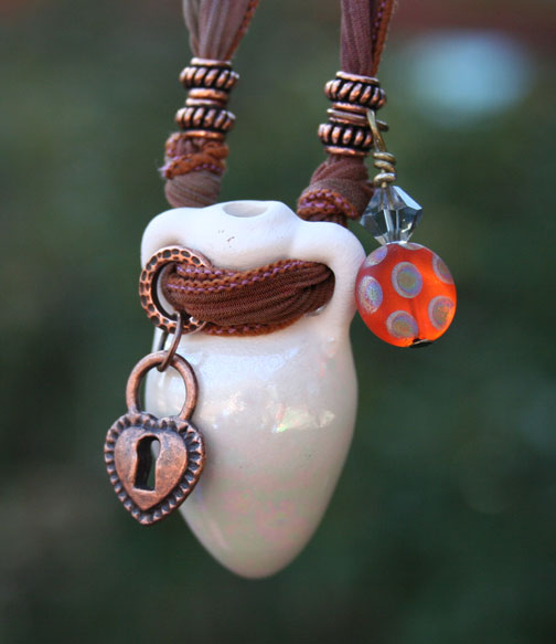 Aromatherapy amphora pendant with silk ribbon, copper beads and charms