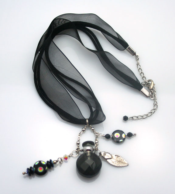 Dramatic black choker with beautiful beads and a mini-perfume bottle
