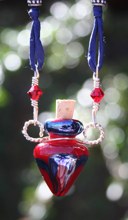 close-up of lampwork glass aromatherapy bottle necklace