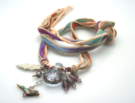 Aromatherapy necklace on hand-painted silk ribbon with antique beads and a sterling silver leaf.