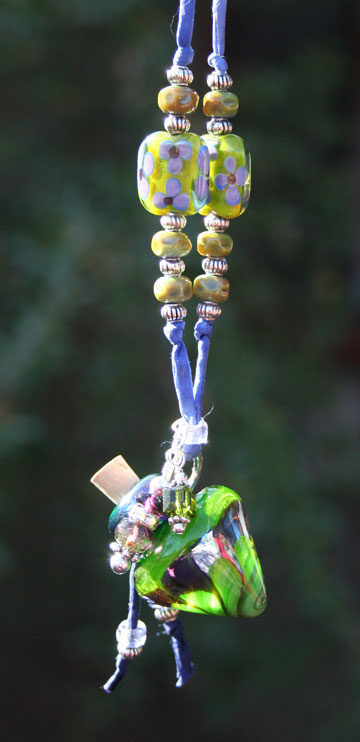 view back of aromatherapy necklace hanging in the sunshine