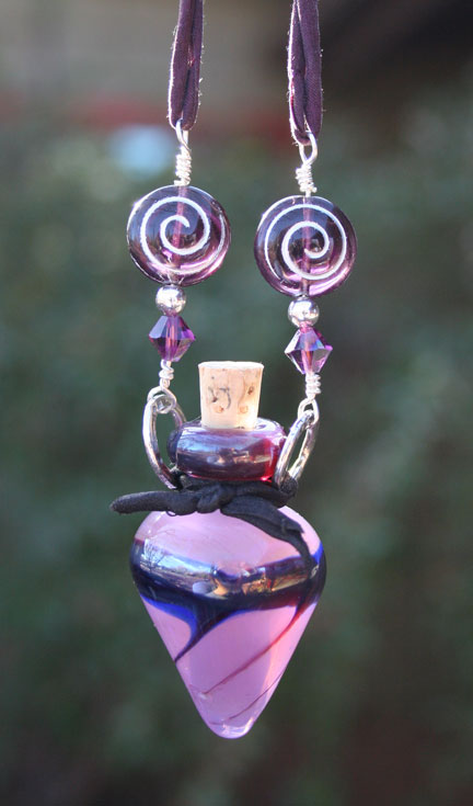 purple spiral beads and lampwork glass poison bottle