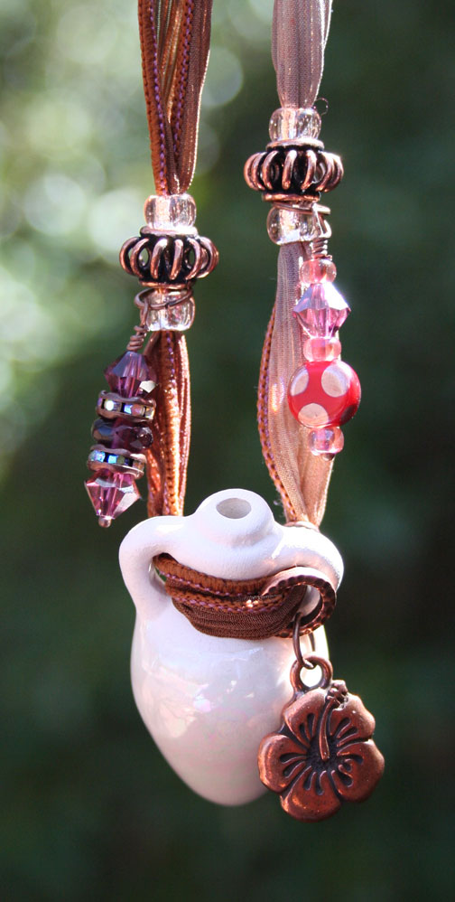 closeup photo of aromatherapy necklace hanging in the sunshine