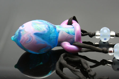 swirling shades of pink, purple, aqua blue and teal facinate anyone who gazes upon this aromatherapy vessel necklace