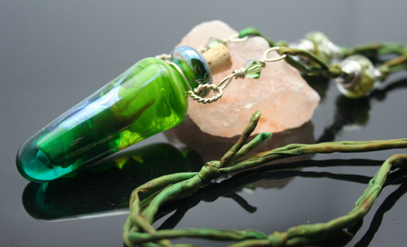 A stunning piece! Aromatherapy jewelry in bright green glass with silk cord, and beautiful silver and glass beads.