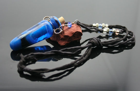 Aromatherapy necklace -  a daring, bright blue and black glass bottle necklace