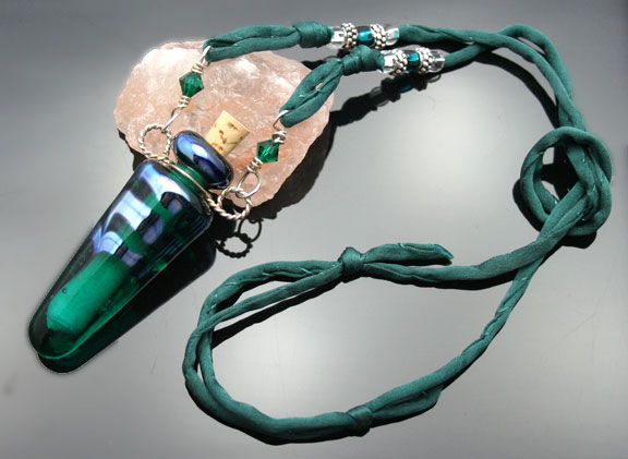 Green glass aromatherapy bottle jewelry on silk cord with pretty silver and glass beads