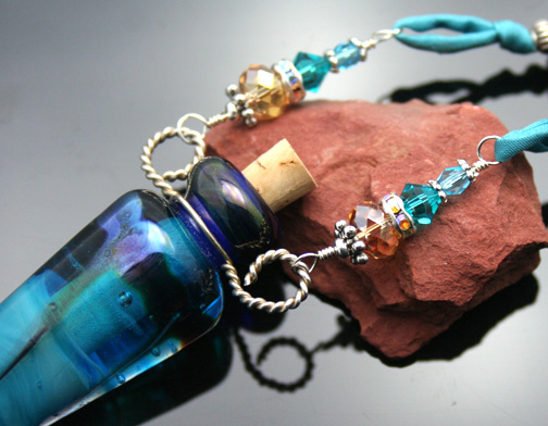 Beautiful turquoise glass aroma pendant on watercolor silk cord with pretty silver and glass beads 