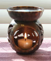 Photo of our large soapstone aromatherapy diffuser featuring elegantly carved sunflowers around the base