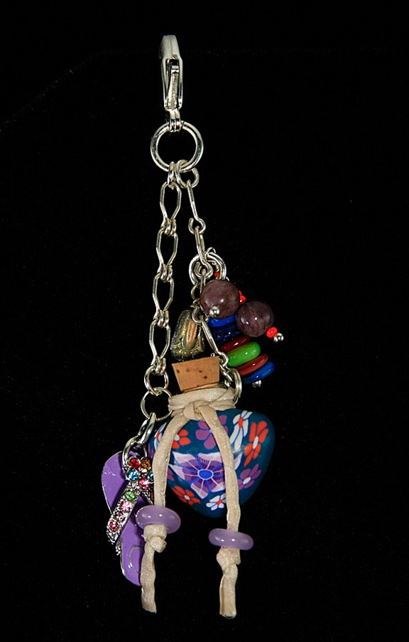 This piece of aromatherapy jewelry can clip onto your purse or belt loop.