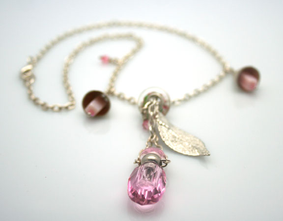 Aromatherapy jewelry with pink faceted mini-perfume bottle, sterling silver chain and pretty bells and beads