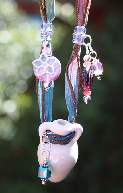 photo of the unique and beautiful aromatherapy necklace hanging in the sun